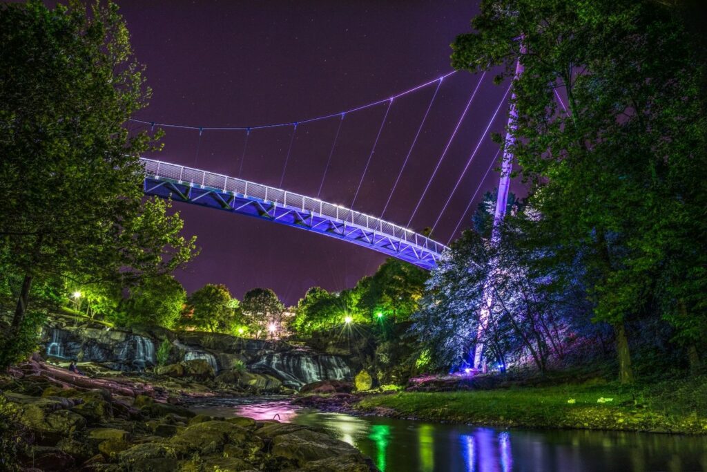 Bridge over river at night in Greenville, SC