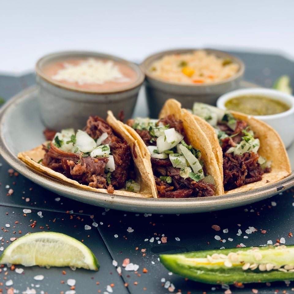 a plate of tacos with sauces and peppers Quixote Brevard NC