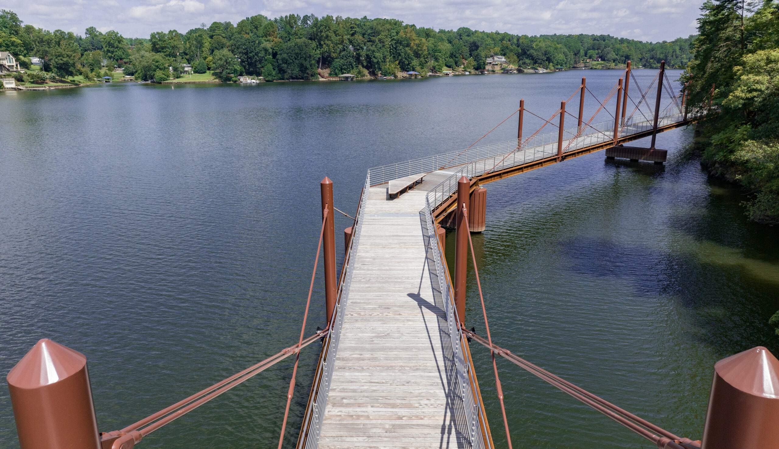 a bridge over water with trees in the background